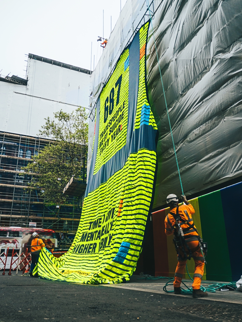 A giant piece of artwork made up of 687 high-vis vests - created for Mental Health Awareness Week (15th-21st May) by IronmongeryDirect and ElectricalDirect - has been displayed on a London construction site to represent the annual number of trade suicides in the UK.