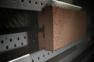 Forterra brand Omnia has launched what is billed as the first UK-manufactured extruded brick slip system where the full system – including rails, fixings, and brick slips – can be sourced from a single supplier.